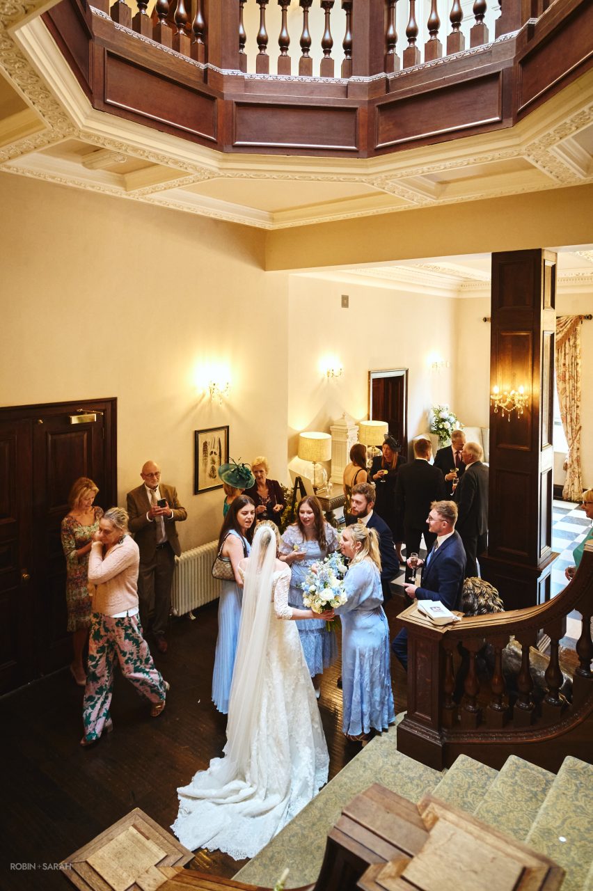 Bride chats with bridesmaids and wedding guests during wedding reception at Bourton Hall in Warwickshire