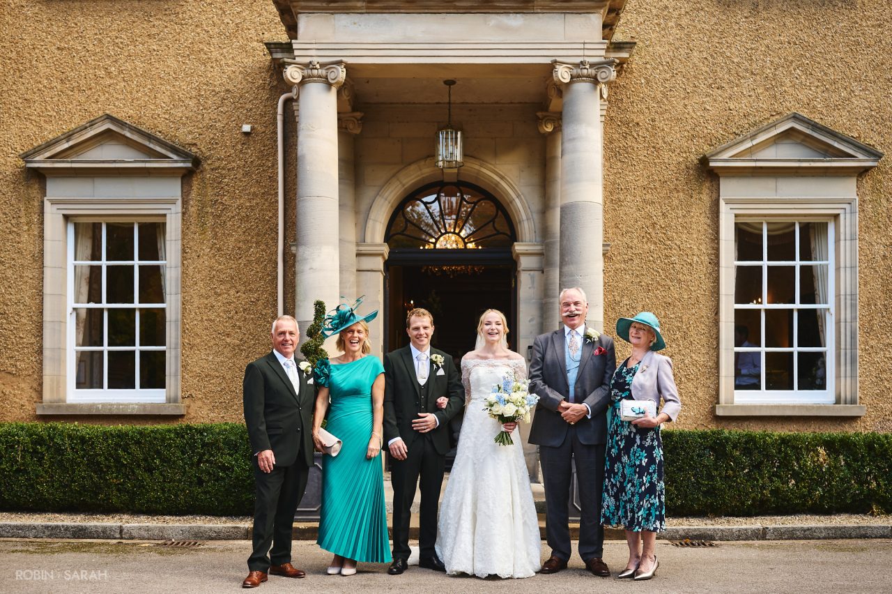 Wedding group photo in front of main house at Bourton Hall in Warwickshire