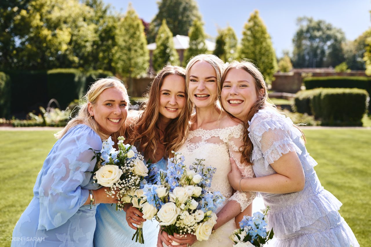 Bride and bridesmaids group photo in the grounds at Bourton Hall
