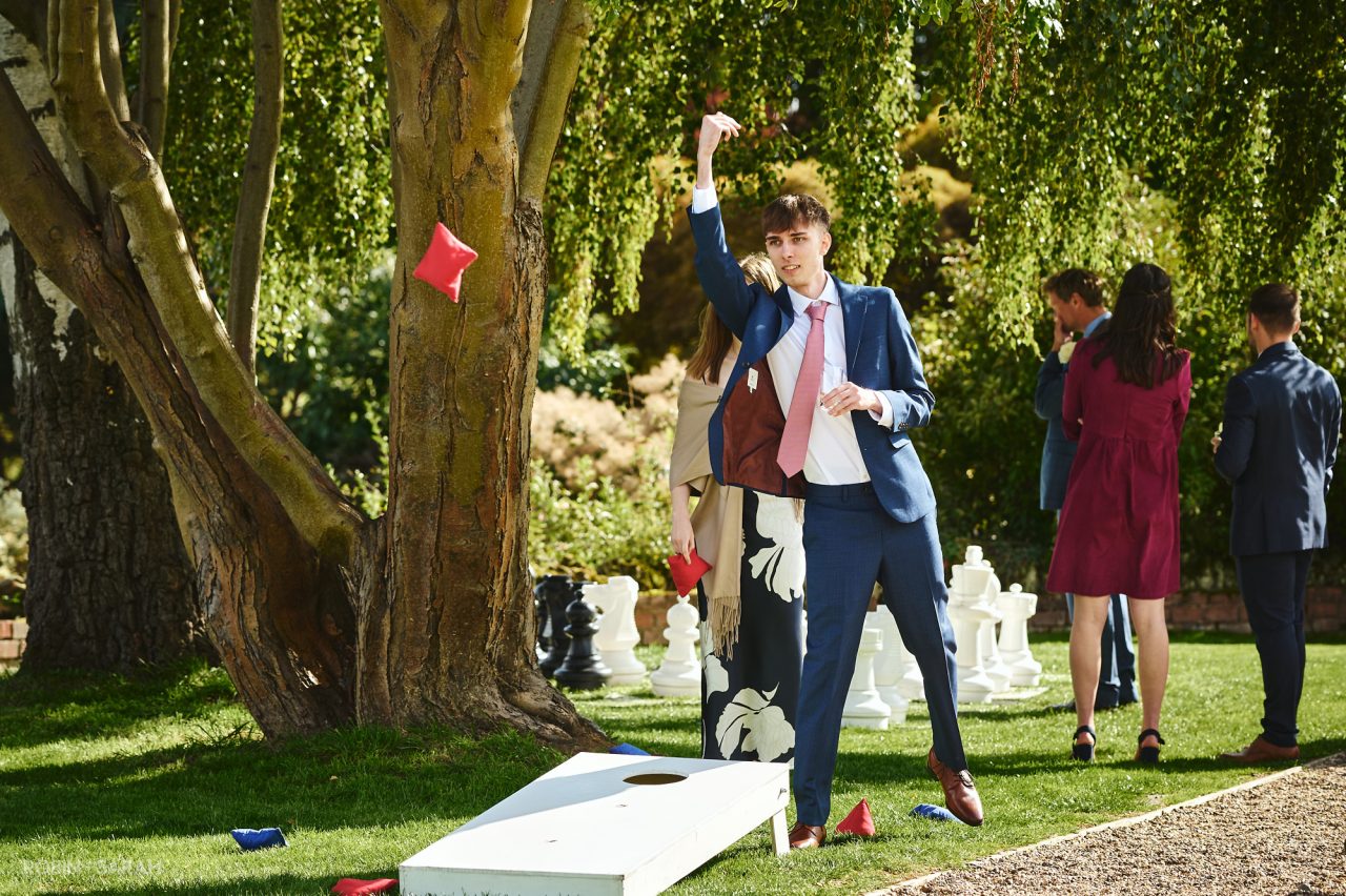 Wedding guest playing lawn games at Bourton Hall