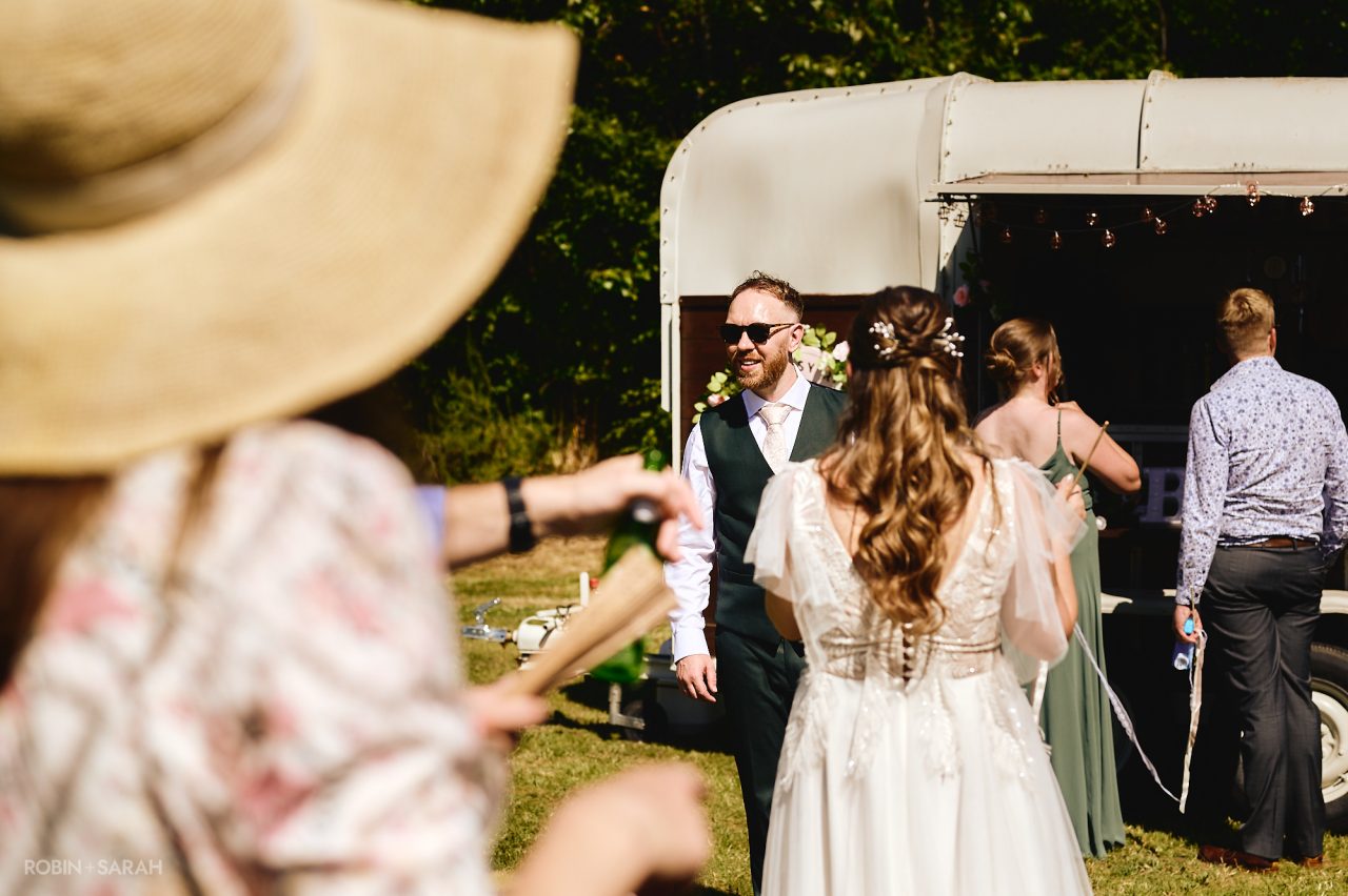 Groom smiling as he watches wedding guests