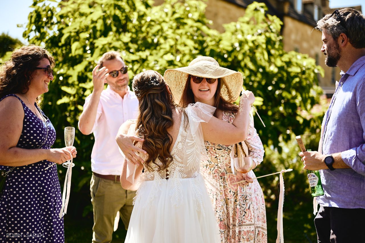 Bride hugged by wedding guests