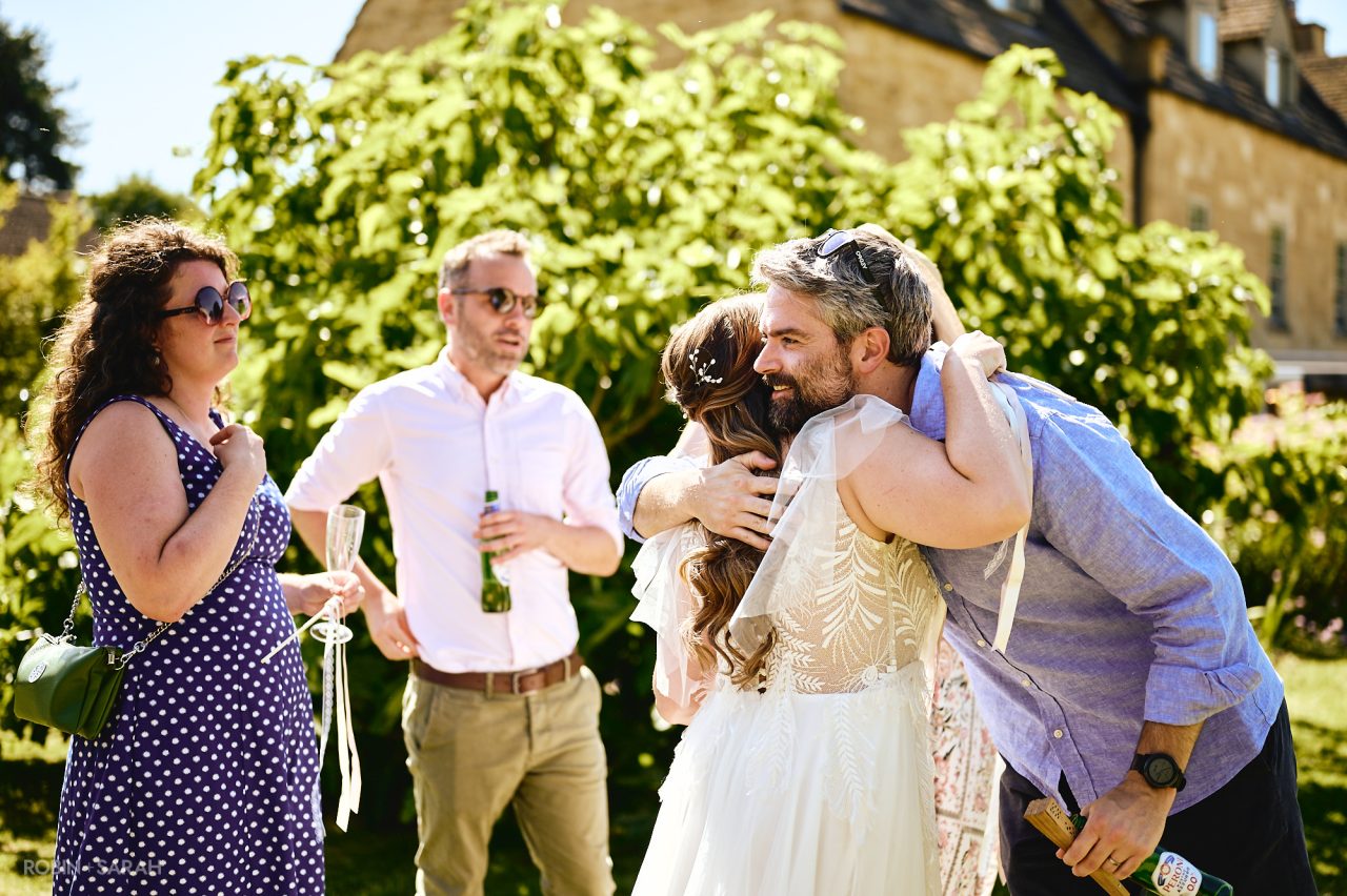 Bride gets hugged by wedding guests