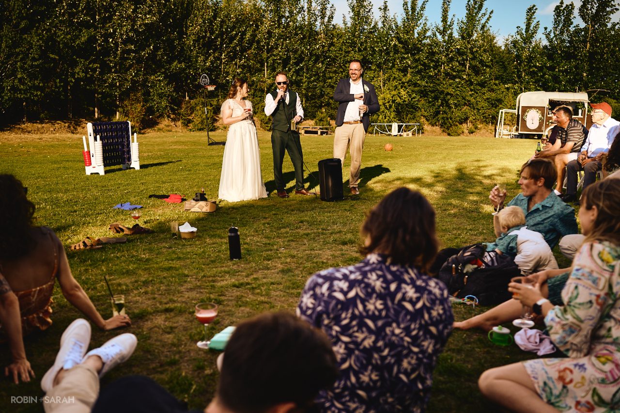 Wedding speeches outside in the gardens at Charingworth House