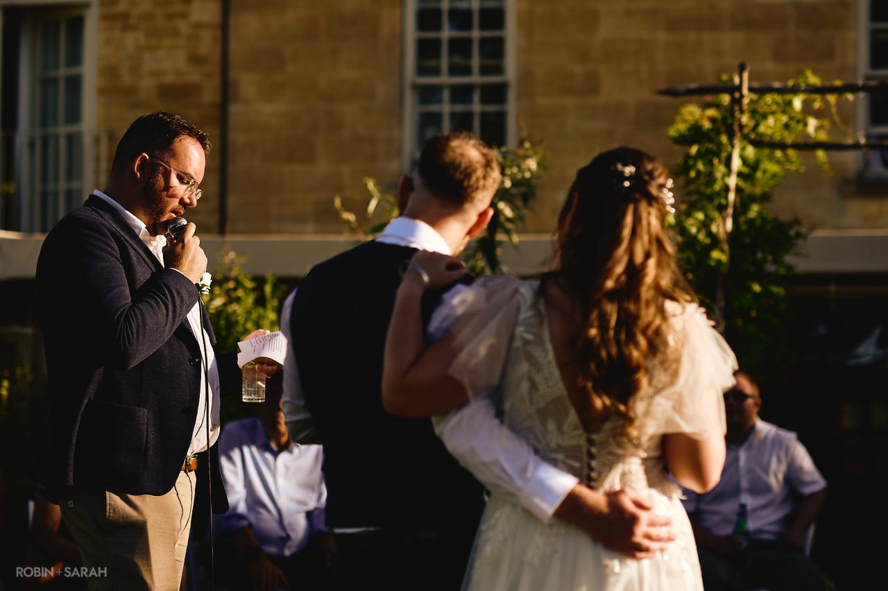Wedding speeches outside in the gardens at Charingworth House