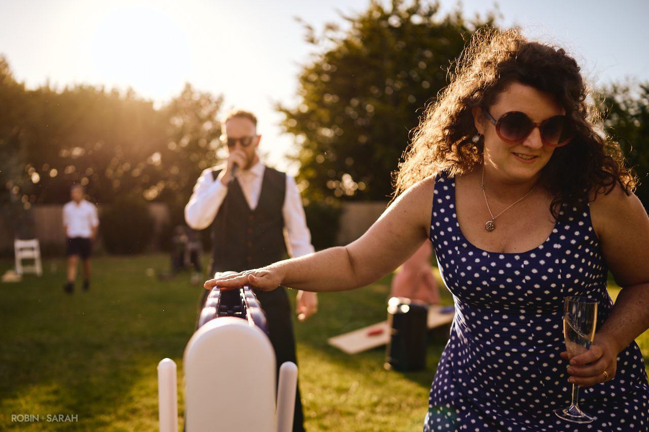 Wedding guests playing giant Connect 4 in the gardens at Charingworth House