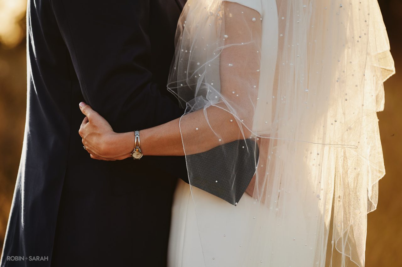 Detail of bride's veil backlight by setting sun