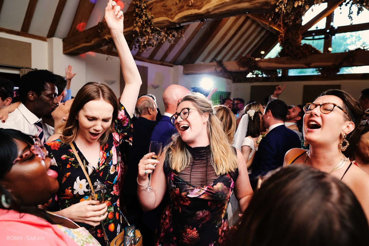 Wedding guests dancing during wedding reception party in barn at Wethele Manor