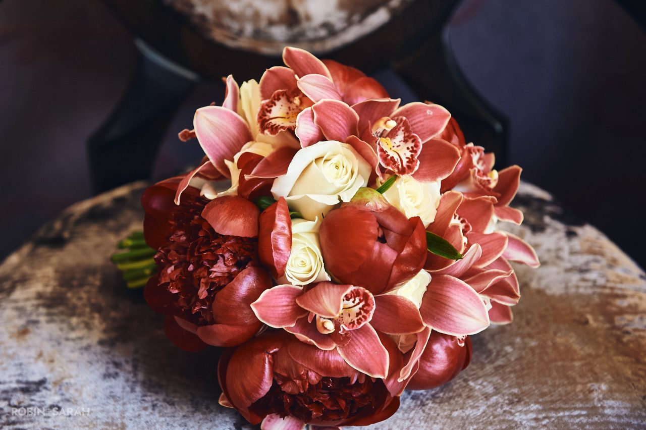 Detail of bride's bouquet with red and cream flowers
