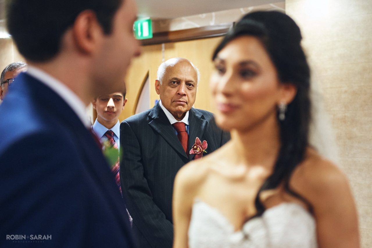 Bride's dad looks on during wedding ceremony