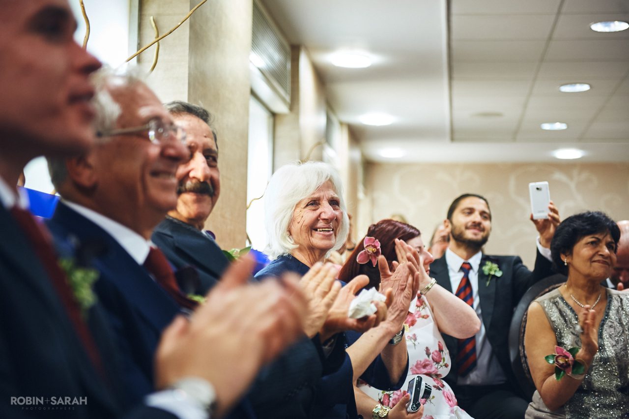 Wedding guests clapping and smiling at end of ceremony at Solihull Register Office