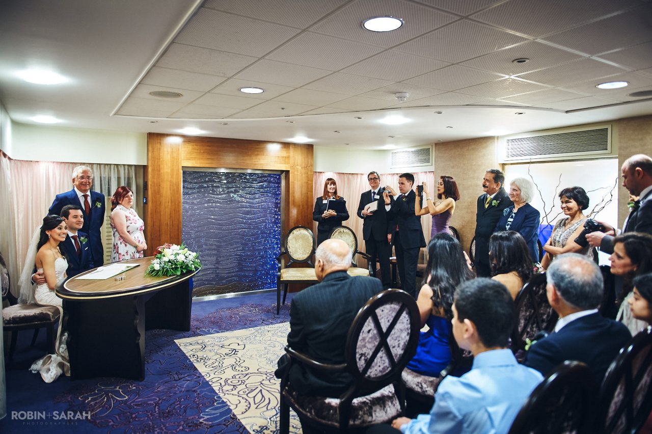 Bride and groom sign marriage register in Ceremony Suite at Solihull Register Office