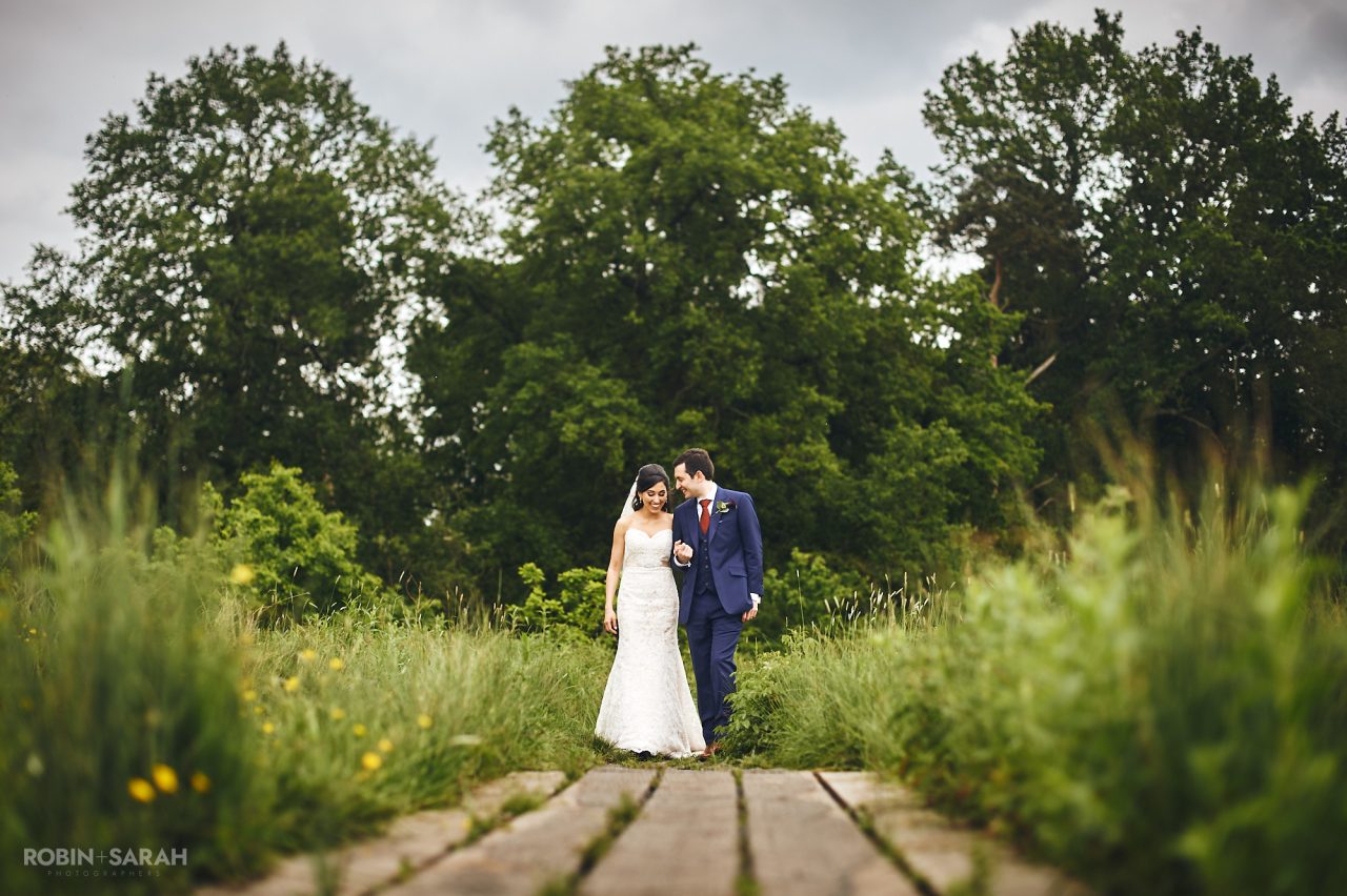 Bride and groom walking through Brueton Park, Solihull