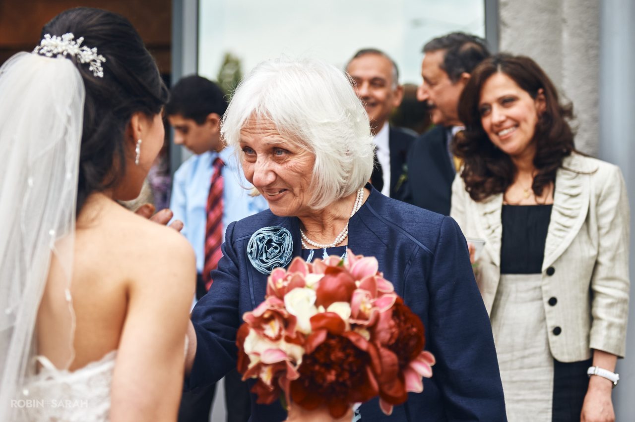 Wedding guests congratulate couple after ceremony at Solihull Register Office