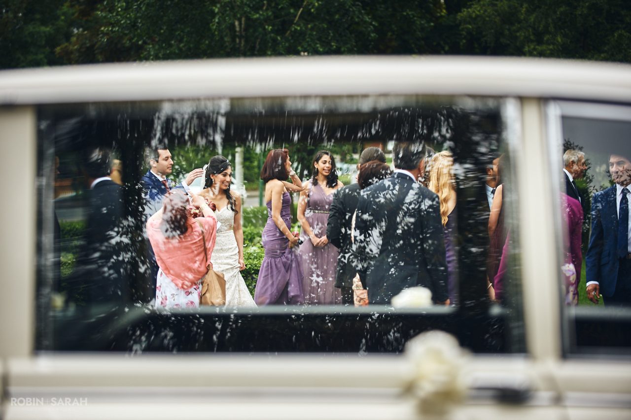 View through car windows of wedding guests at Solihull Register Office